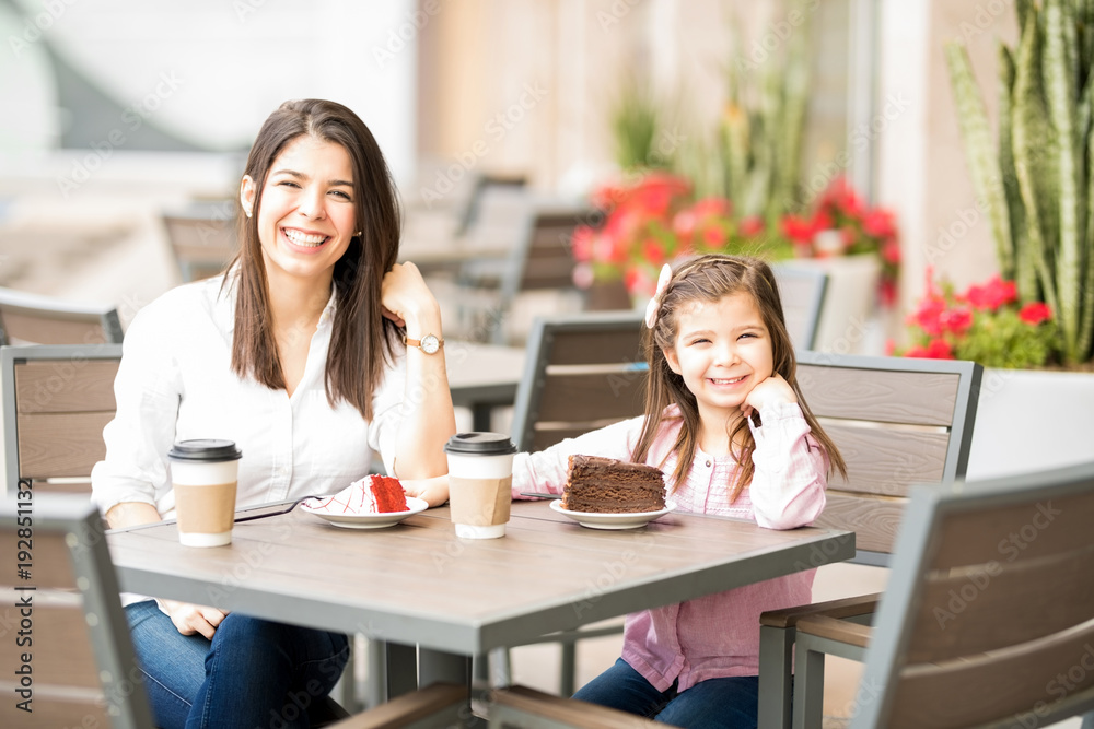Hispanic mother and daughter hanging out at a restaurant Hispanic mother and daughter hanging out at a restaurant