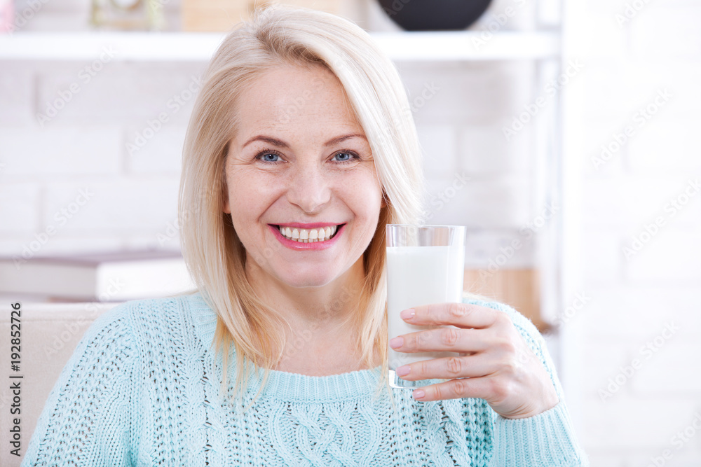Happy middle aged woman drinking milk Happy middle aged woman drinking milk