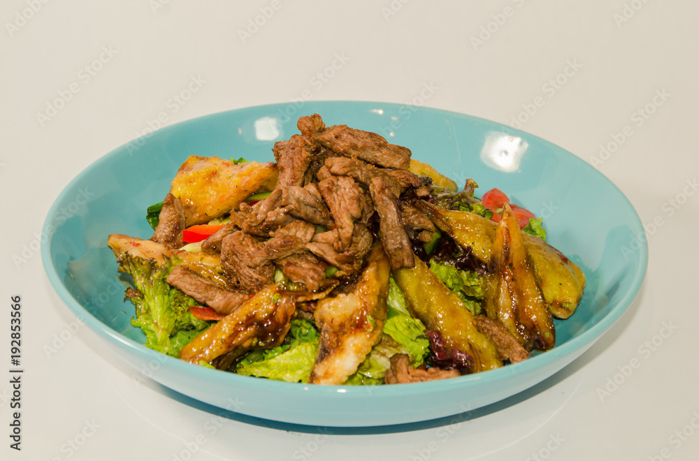 pieces of meat stewed with vegetables on a white background pieces of meat stewed with vegetables on a white background