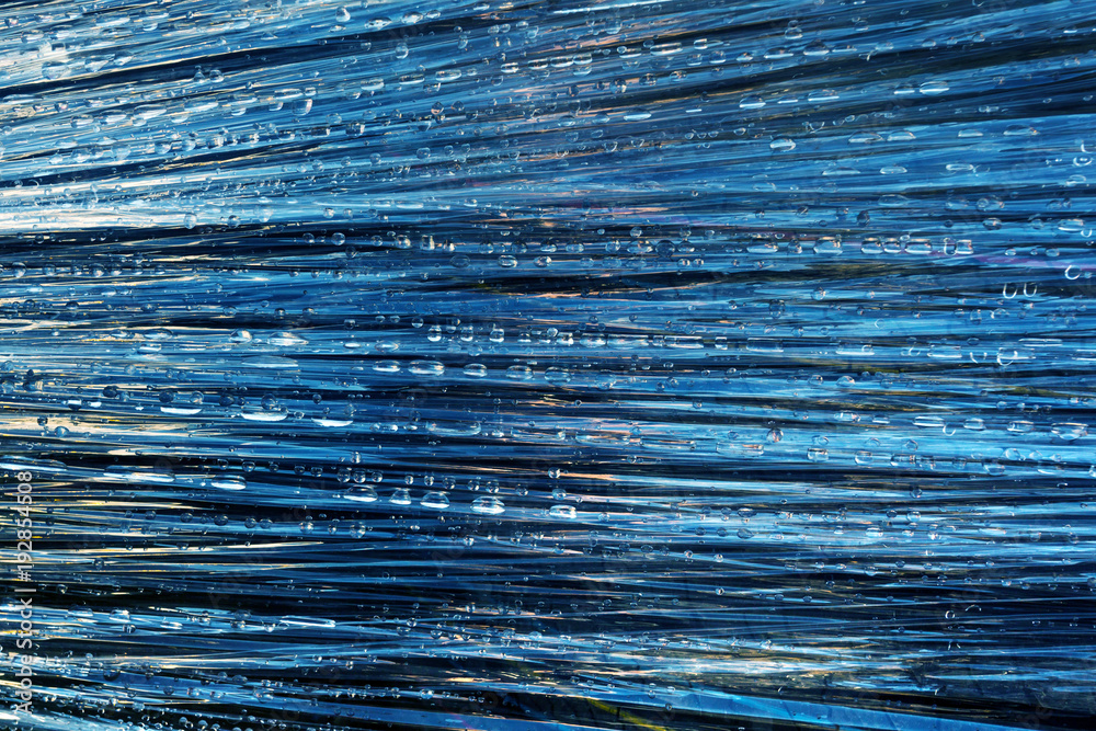 Fototapeta premium Rain drops on polyethylene film. Abstract background.