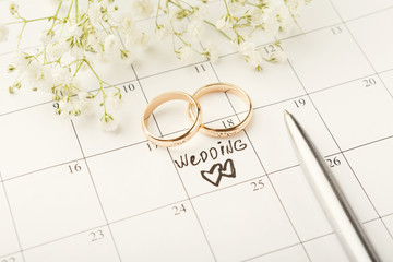 Word wedding on calendar with sweet flowers