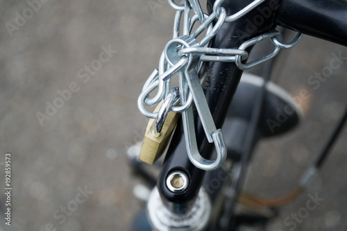 Padlock bicycle lock Close-up lock with security chain attached.