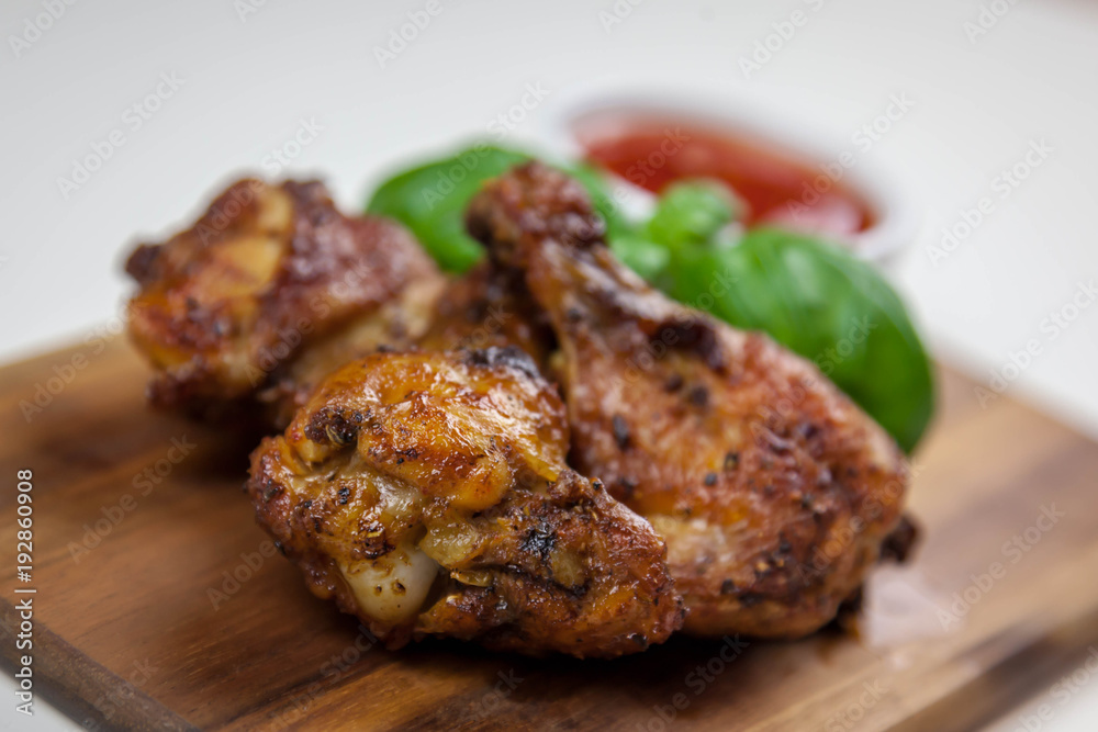 Chicken wings with sweet chilli sauce on the white background Chicken wings with sweet chilli sauce on the white background