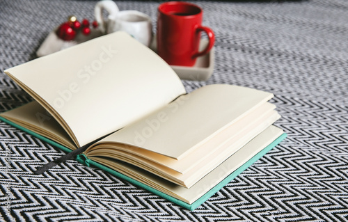 A tray with two cups and an open book with clean pages