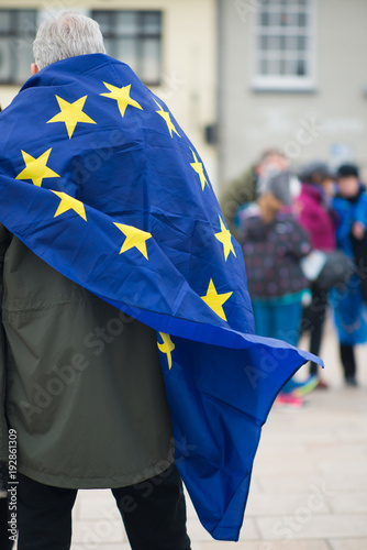 man draped in European Union flag at Brexit demonstration