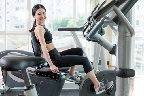 Woman hapiness when she exercise by spin bike.