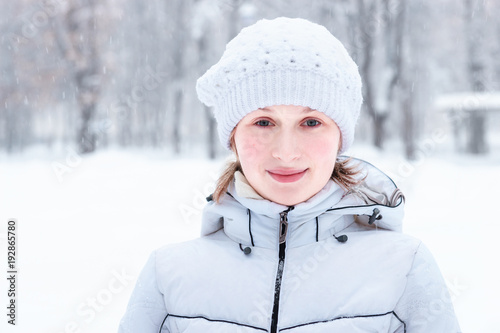 Beautiful young woman in the snow in winter