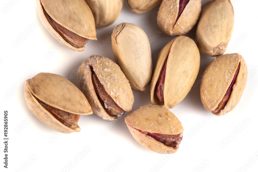 Heap of salted pistachio nuts isolated on a white background Heap of salted pistachio nuts isolated on a white background