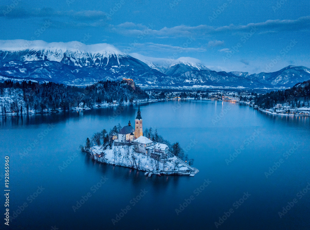 Twilight view of Lake Bled with Bled Island and Bled Castle in winter, Slovenia