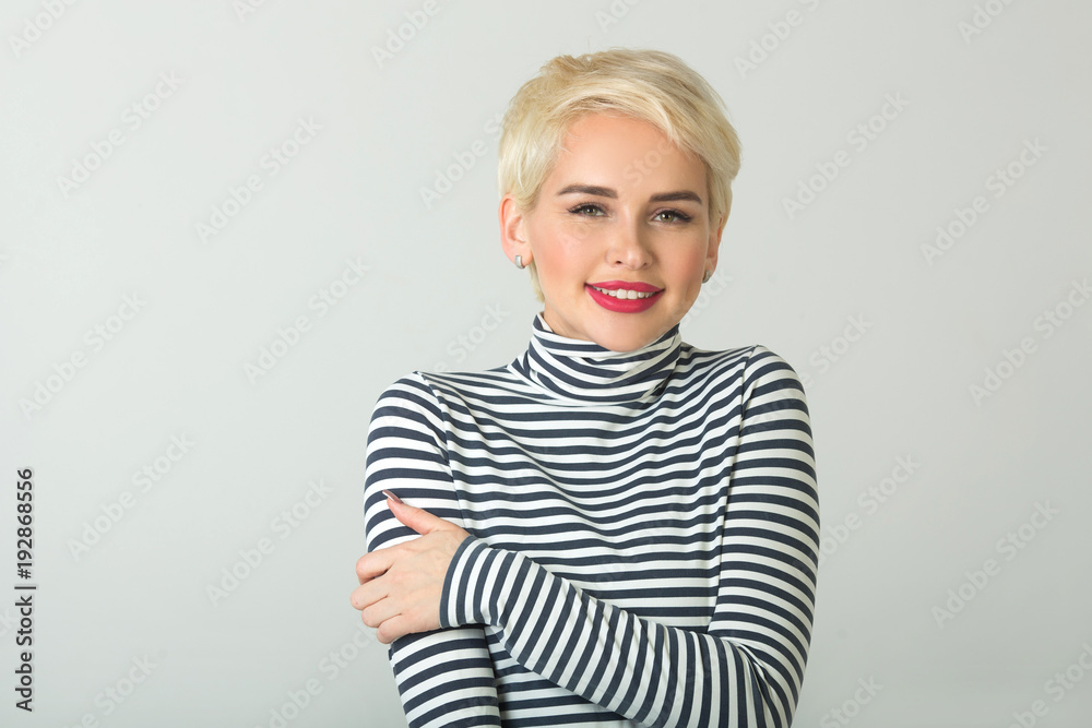 happy beautiful young girl with a smile on her face with a short hairstyle on a light background happy beautiful young girl with a smile on her face with a short hairstyle on a light background