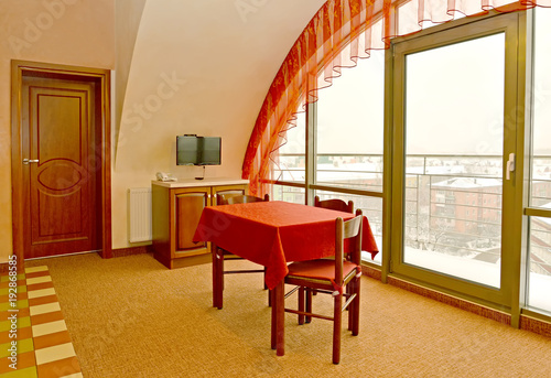 Living room interior fragment with a red cloth on a table