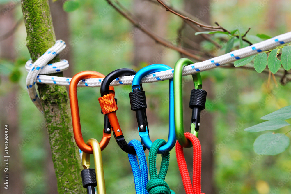 Carabiner with rope on nature background. Carabiner with rope on nature background.