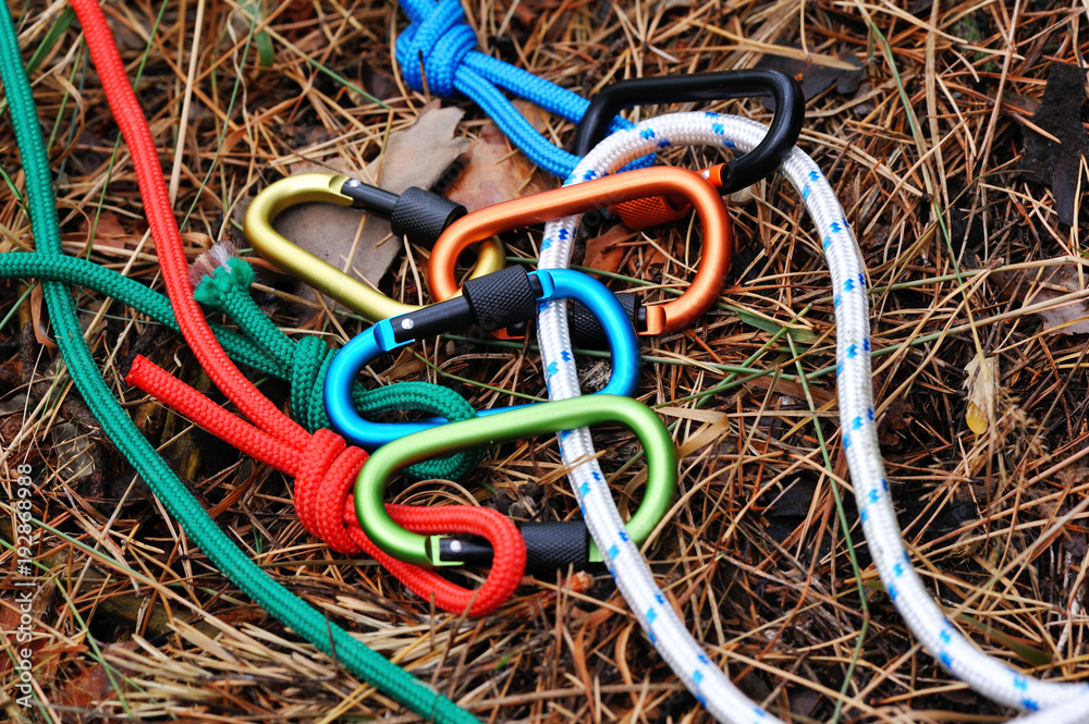 Carabiner with rope on nature background. Carabiner with rope on nature background.