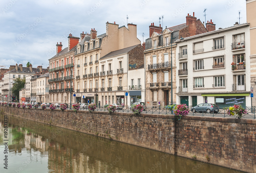 View on beautiful embankment of River Vilaine decorated with flowers in Rennes, Brittany, France