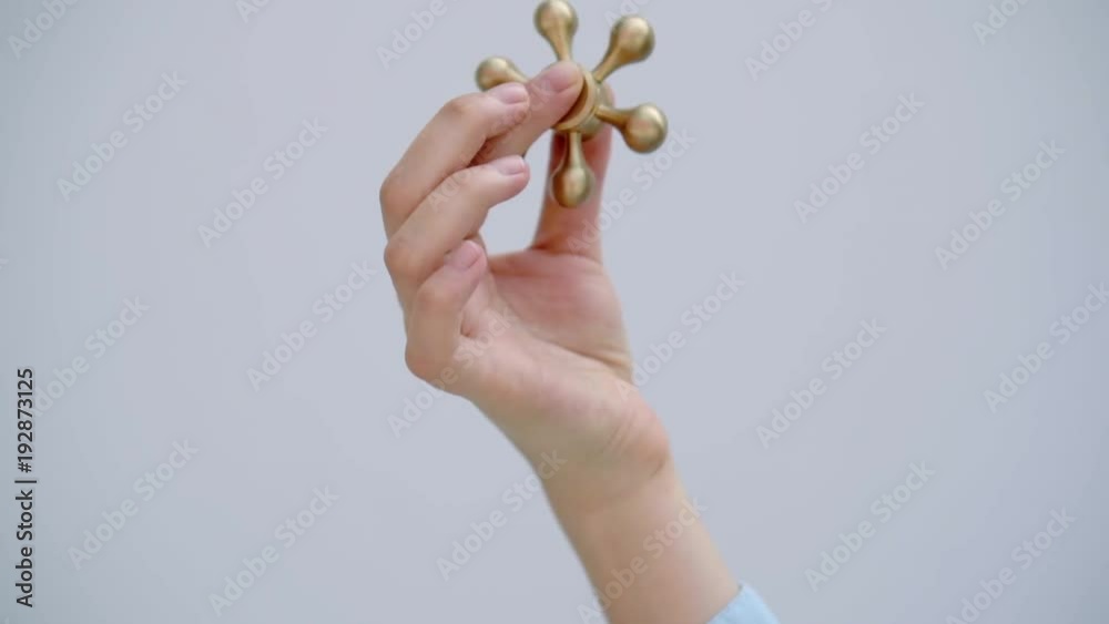 close up shot of a woman's hand, a lady twists a modern popular toy called a spinner, this fashionable object is needed for entertainment and comfort close up shot of a woman's hand, a lady twists a modern popular toy called a spinner, this fashionable object is needed for entertainment and comfort