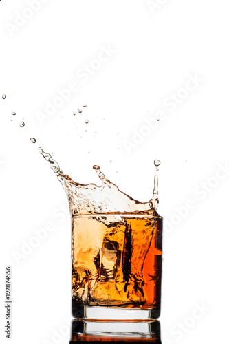 splash of whiskey with ice isolated on white