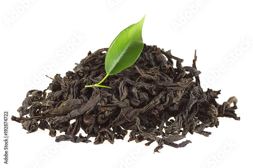 Black tea with green leaf isolated on white background