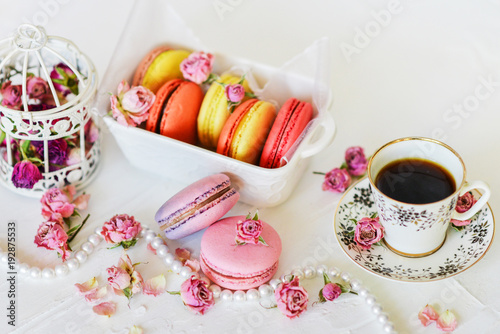 Delicate Fresh Colorful French Macaroons In Pastel Colors With Flowers Roses On A Light Textile Background