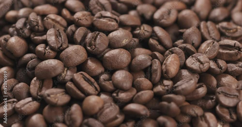 Slow motion closeup coffee beans falling into bowl Slow motion closeup coffee beans falling into bowl