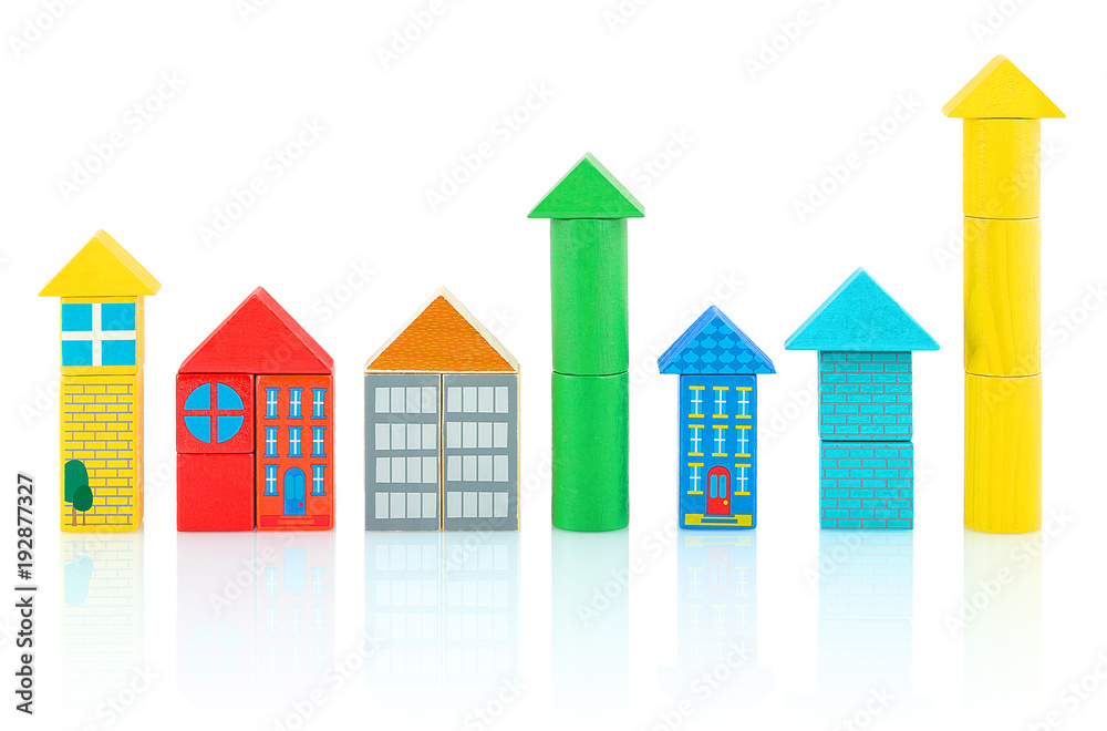 Houses and towers builded from colorful wooden blocks isolated on white background with shadow reflection. Children's wooden toys.