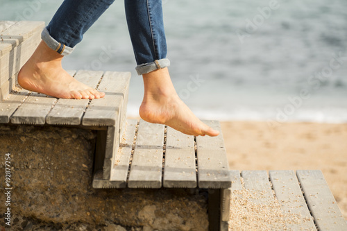 Going down the stairs on the beach with bare feet