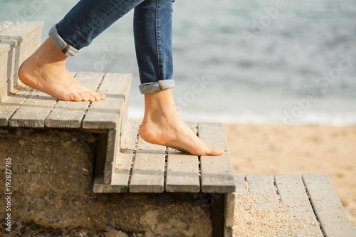 Going down the stairs on the beach with bare feet