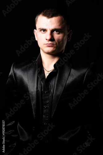 Studio portrait of a young guy with a short haircut in brown sunglasses photo