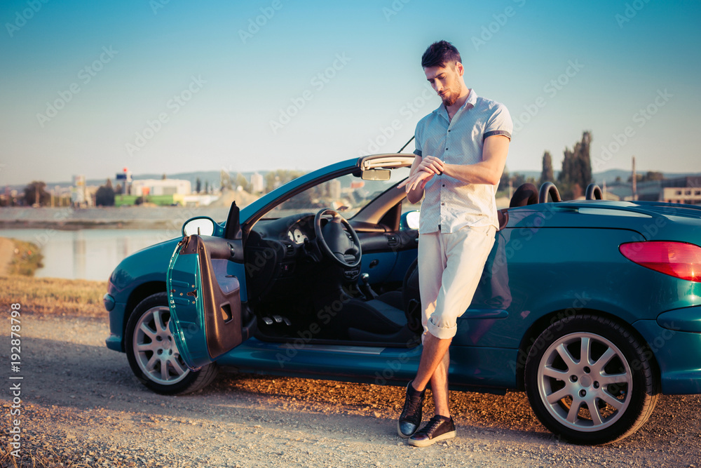 Naklejka premium Stylish young man in cabriolet