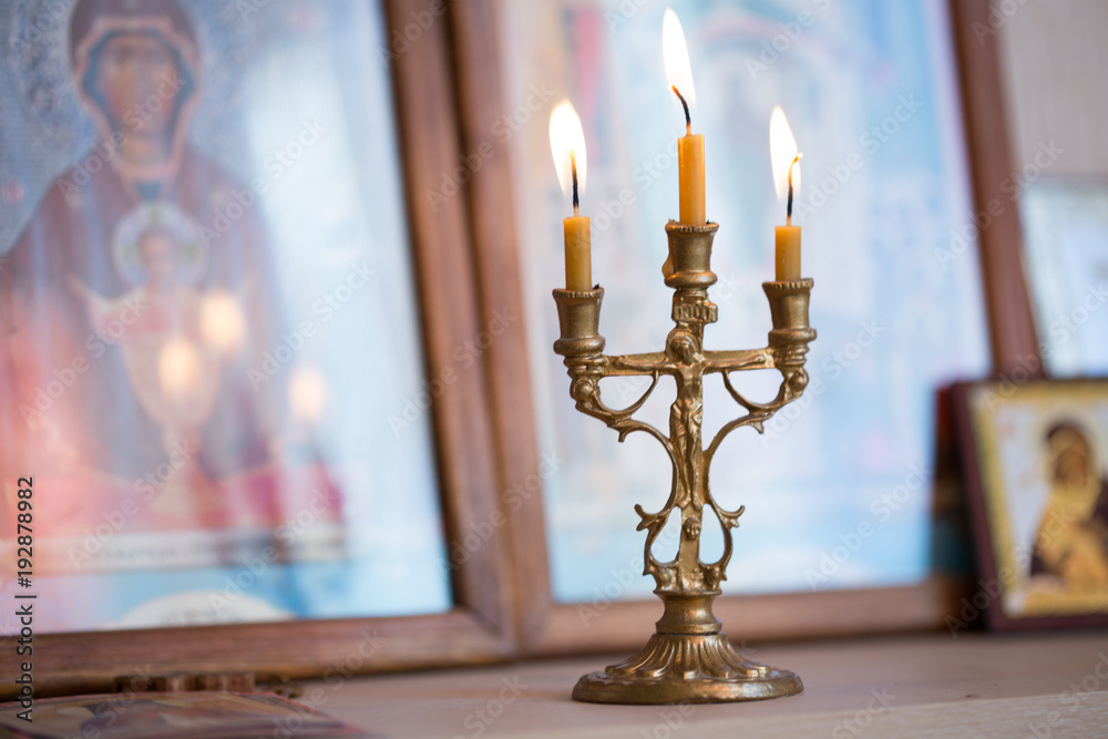 candle against the background of orthodox icons candle against the background of orthodox icons