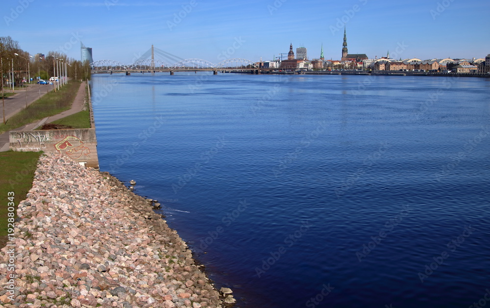 View at river in  Riga, Latvia, shores and bridge, buildings in background