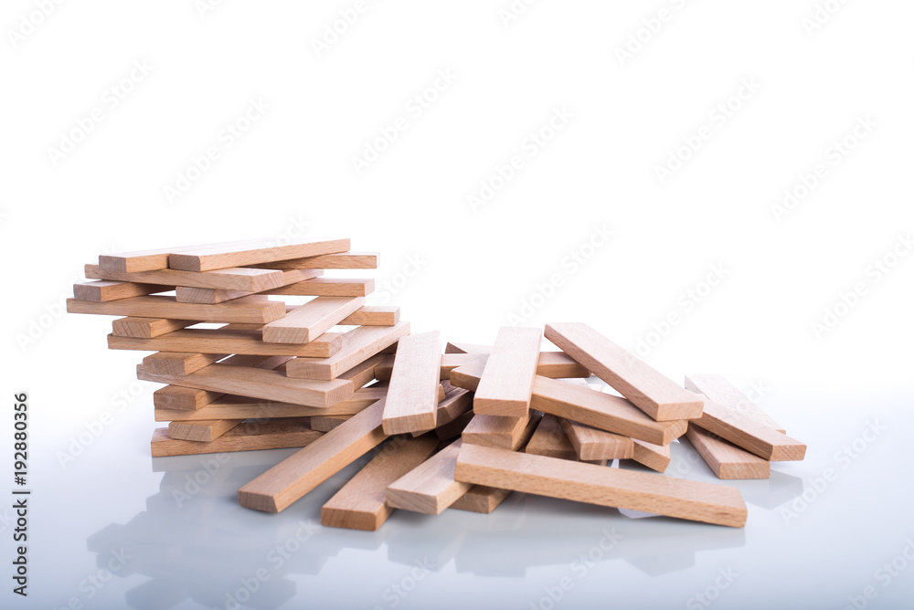 Wooden blocks on white background, children development toys, reflection and shadows on surface,