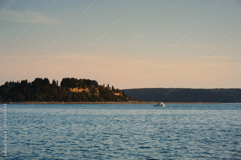 Motorboat sailing on the sea, quiet cruise on the blue water, active rest summer vacation. Pier city background Motorboat sailing on the sea, quiet cruise on the blue water, active rest summer vacation. Pier city background