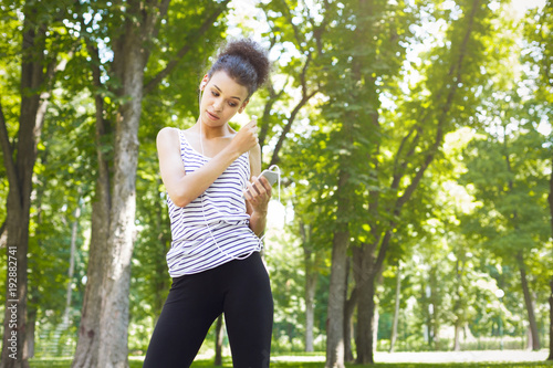 African-american woman posing at bright wall photo