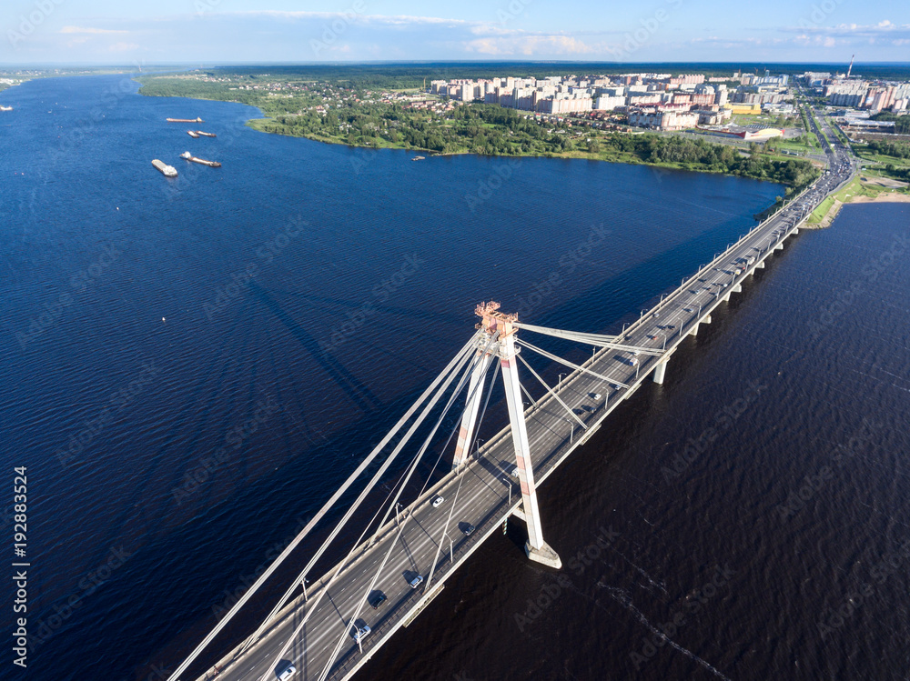 Top view of the Octyabrsky Suspension Bridge across the Sheksna river with traffic on highway. Cherepovets, Vologda region, Russia