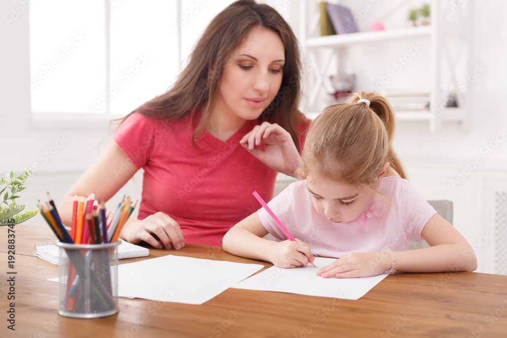 Mother drawing with her daughter Mother drawing with her daughter