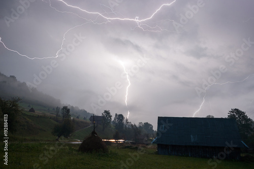 A heavy thunderstorm passes with lots of catched flashes in the small Carpathian mountain village in Ukraine.
