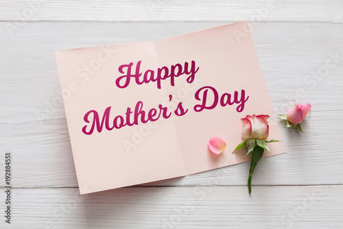 Mothers day background, card and rose flower on white wood