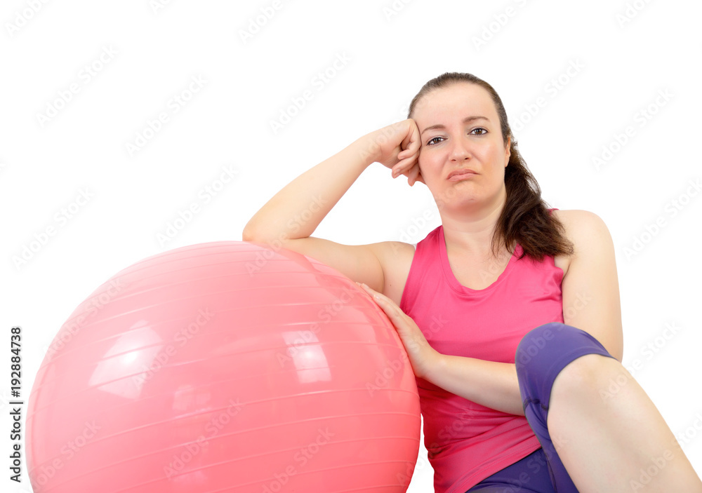 Tired and sad woman doing pilates exercises against a white background Tired and sad woman doing pilates exercises against a white background