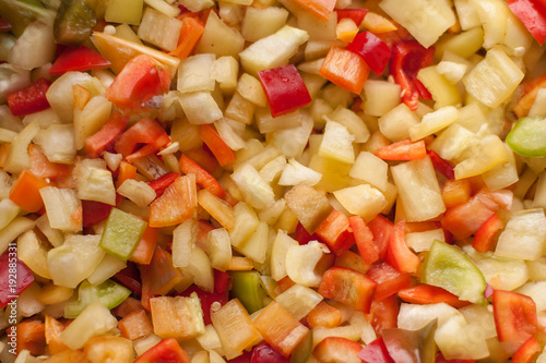cut slices pieces of red, yellow and green sweet bell pepper macro closeup