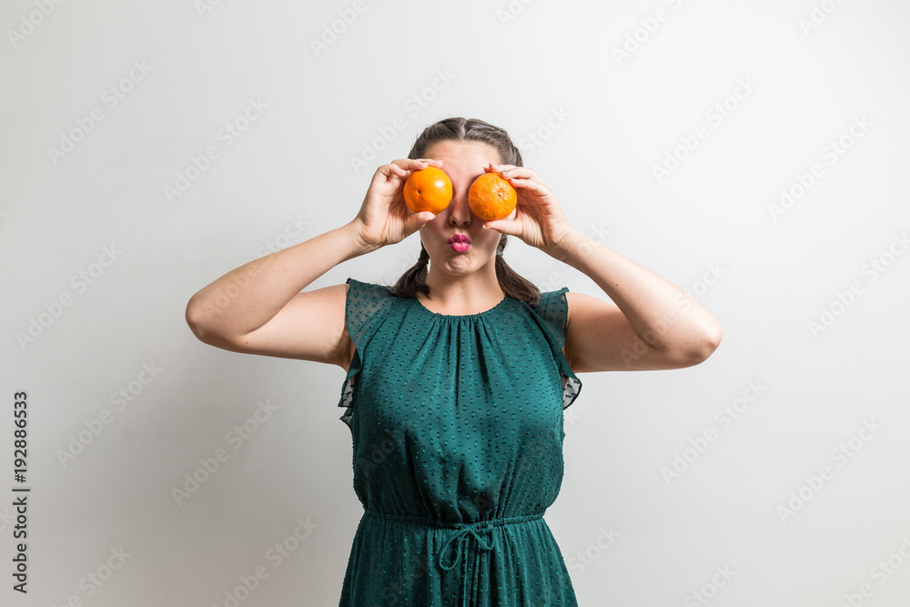 Funny teenager holds fruits over her eyes Funny teenager holds fruits over her eyes