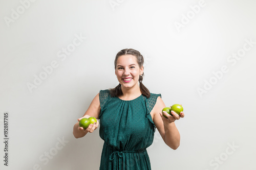 Joyful happy woman carries fruits