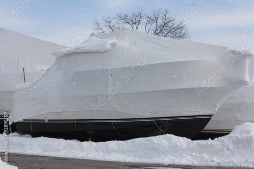Plastic shrink wrap on boat, to protect boat and interior of boat from the winter elements.   

