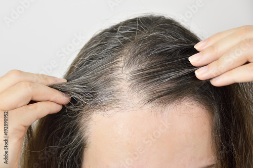 Young woman shows her gray hair