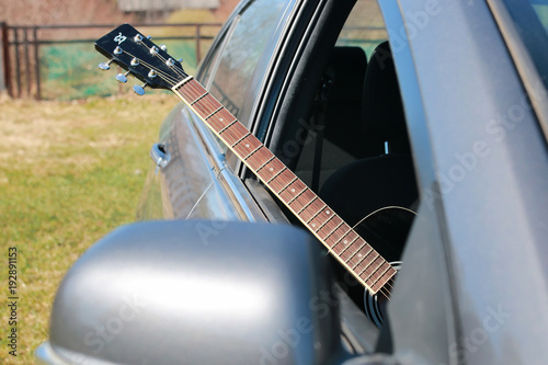 guitar outdoor near car photo