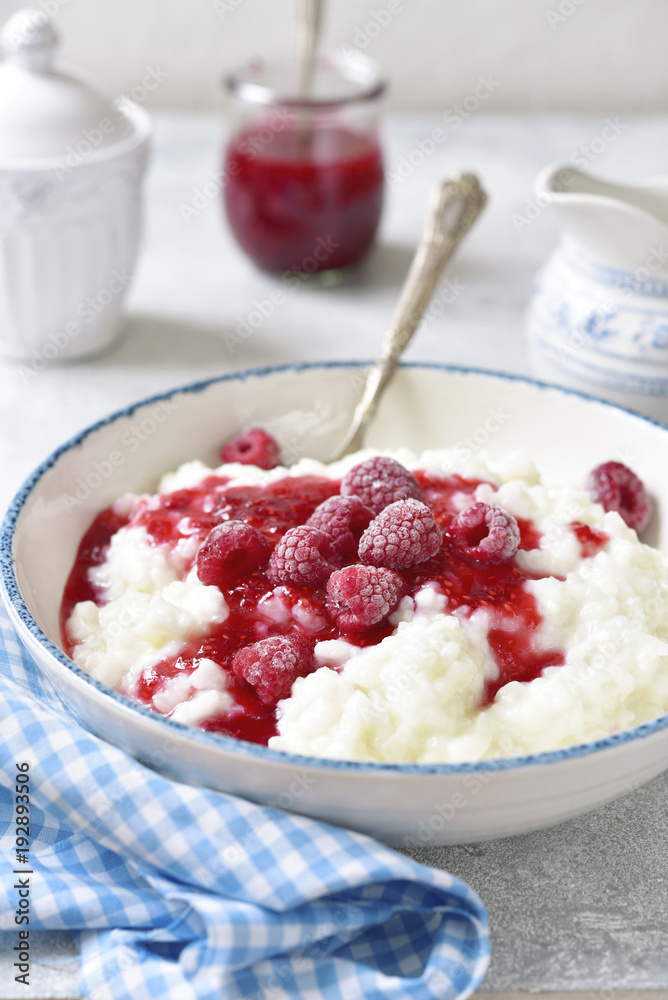 Rice porridge or pudding with berry syrup for a breakfast.