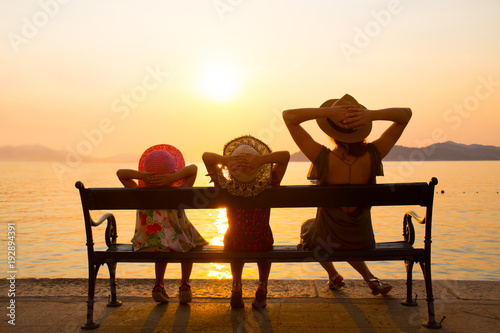 Family with children at sunset by the sea