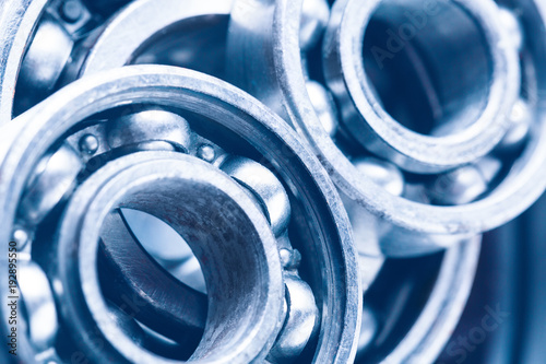 Group of various ball bearings as a background. Close up image with selective focus. Machinery background. photo
