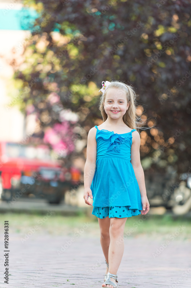 Fototapeta premium Child smiling with long blond hair