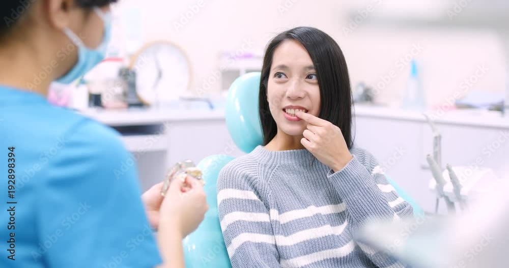 Woman checking her teeth in dental clinic Woman checking her teeth in dental clinic