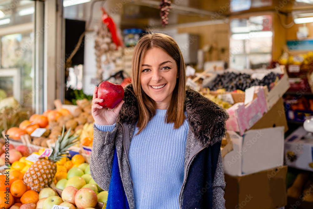 Portrait of smiling woman holding red apple Portrait of smiling woman holding red apple